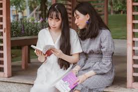 two-women-reading-together