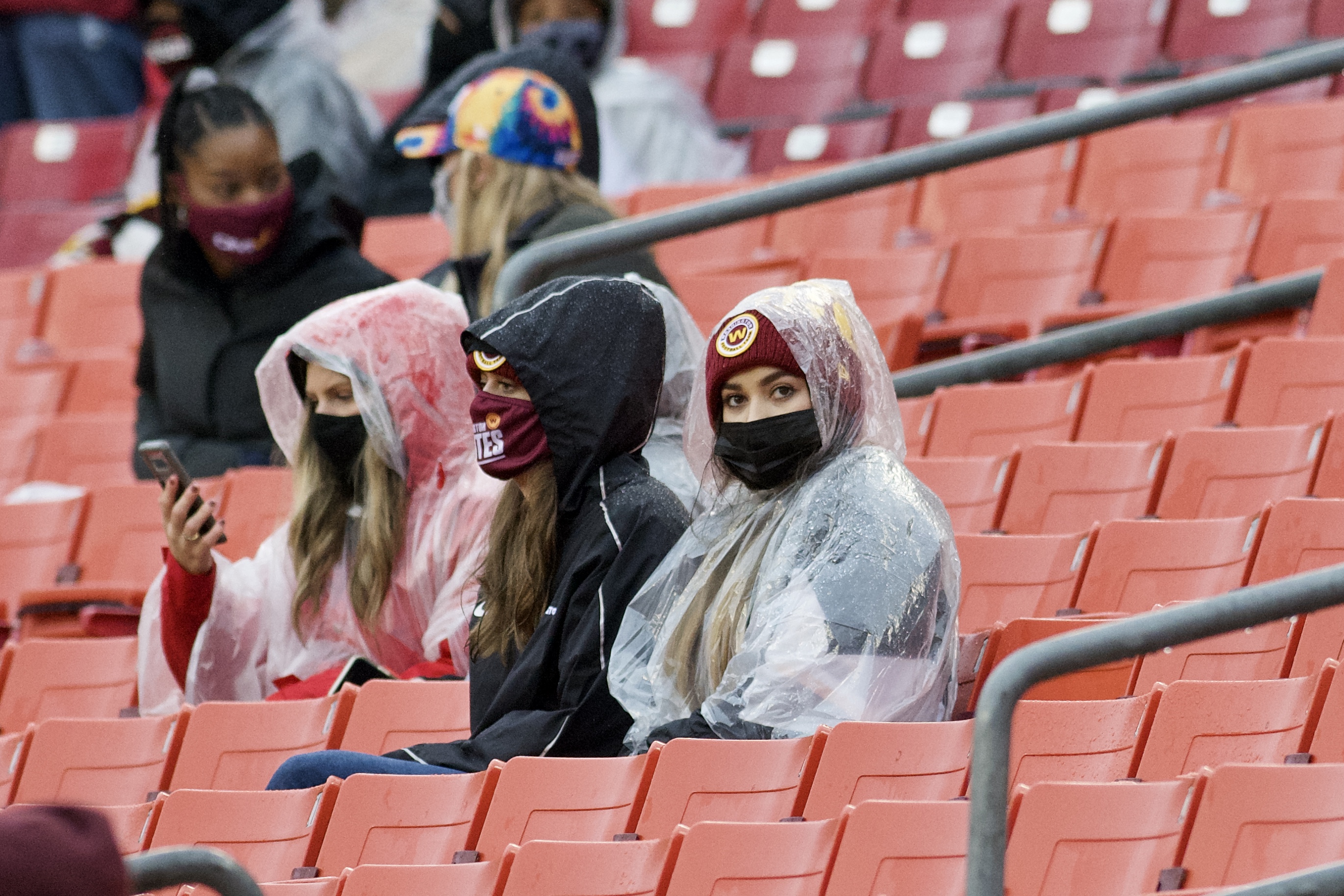 fans-watching-football-wearing-face-masks